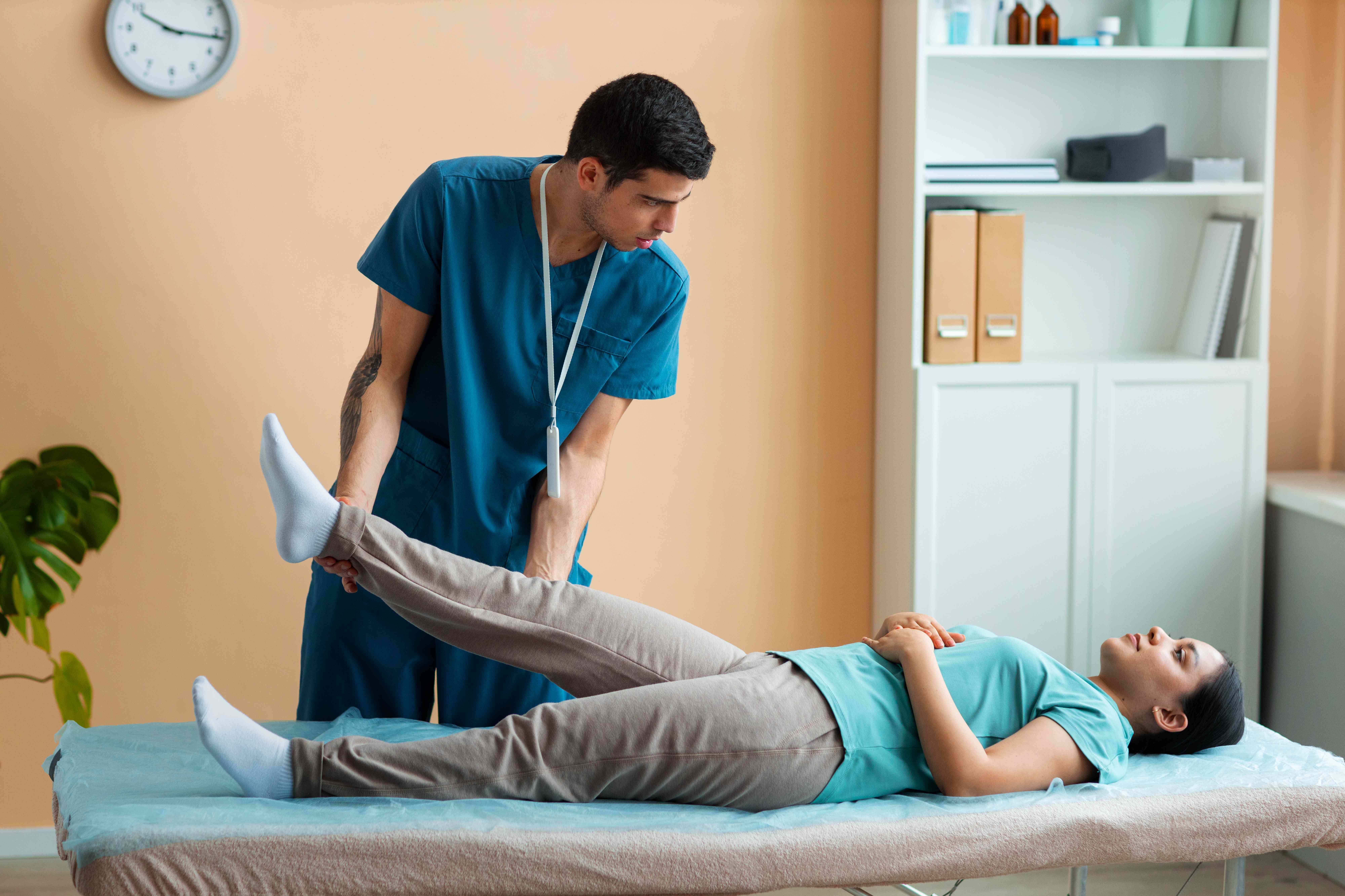 doctor-helping-patient-rehabilitation-compressed (2)